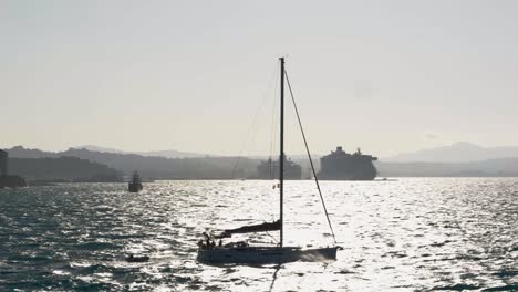 a sailing boat navigating through the turbulent greek waters of the ionian sea near corfu island, towing a pontoon