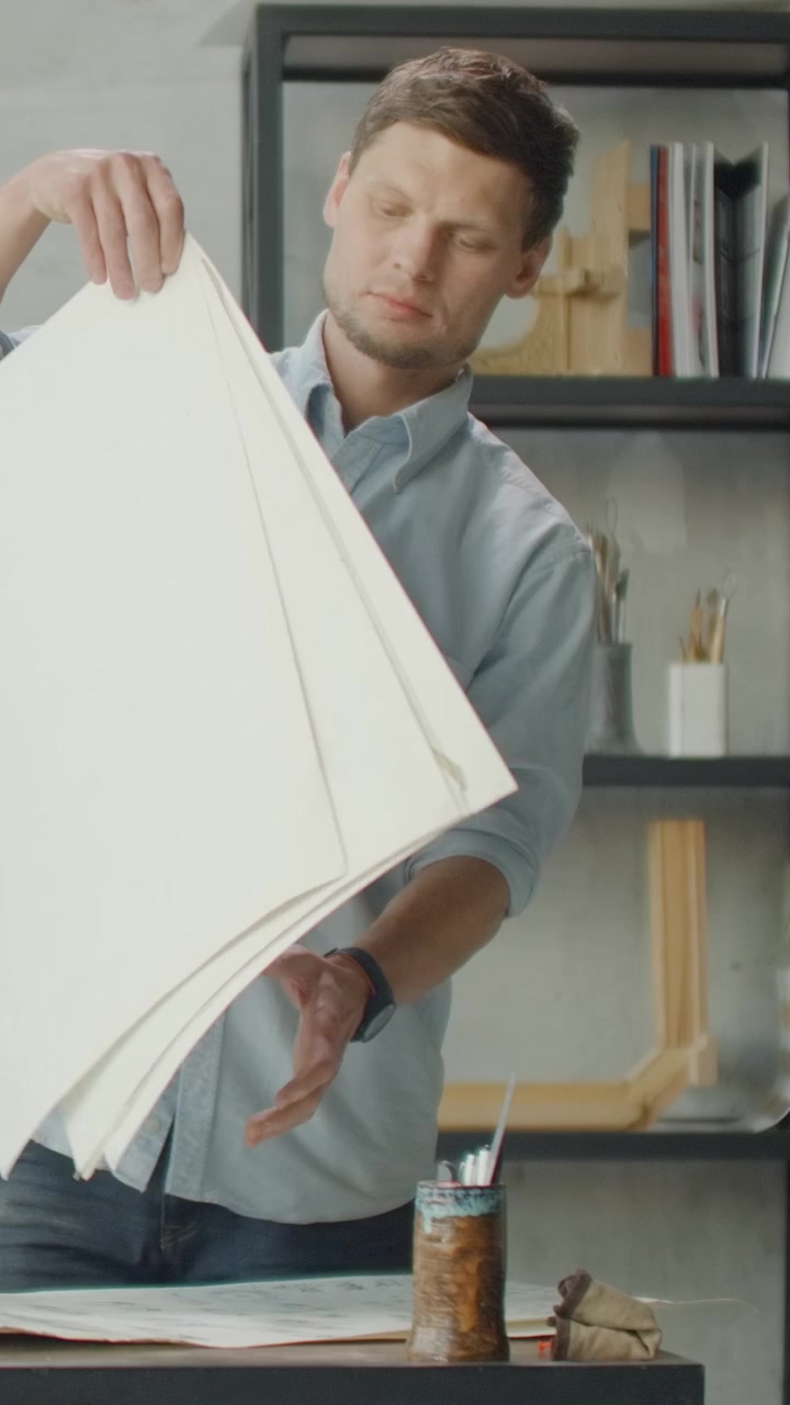 Architect Reviewing Technical Blueprints in Professional Design Studio