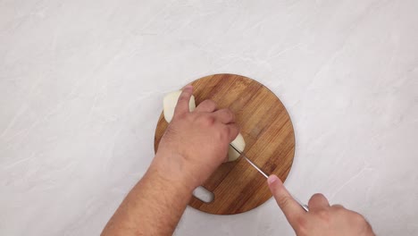 top view of cutting onions on the wooden board