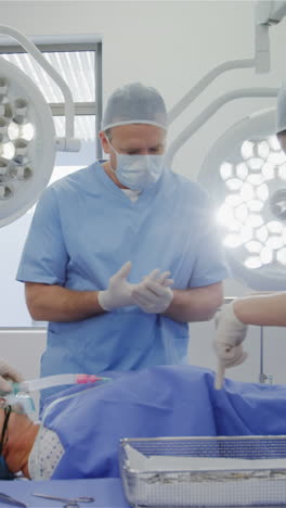 surgery team discussing while operating a patient in an operating room