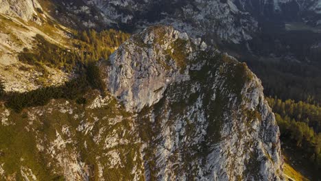 circle movement with a drone filmed beautiful mountains in the alps at sunrise with a clear sky in 4k