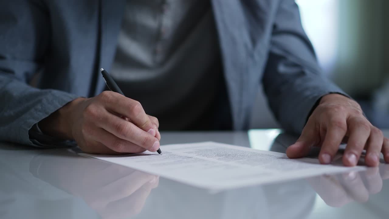 A man signs a document