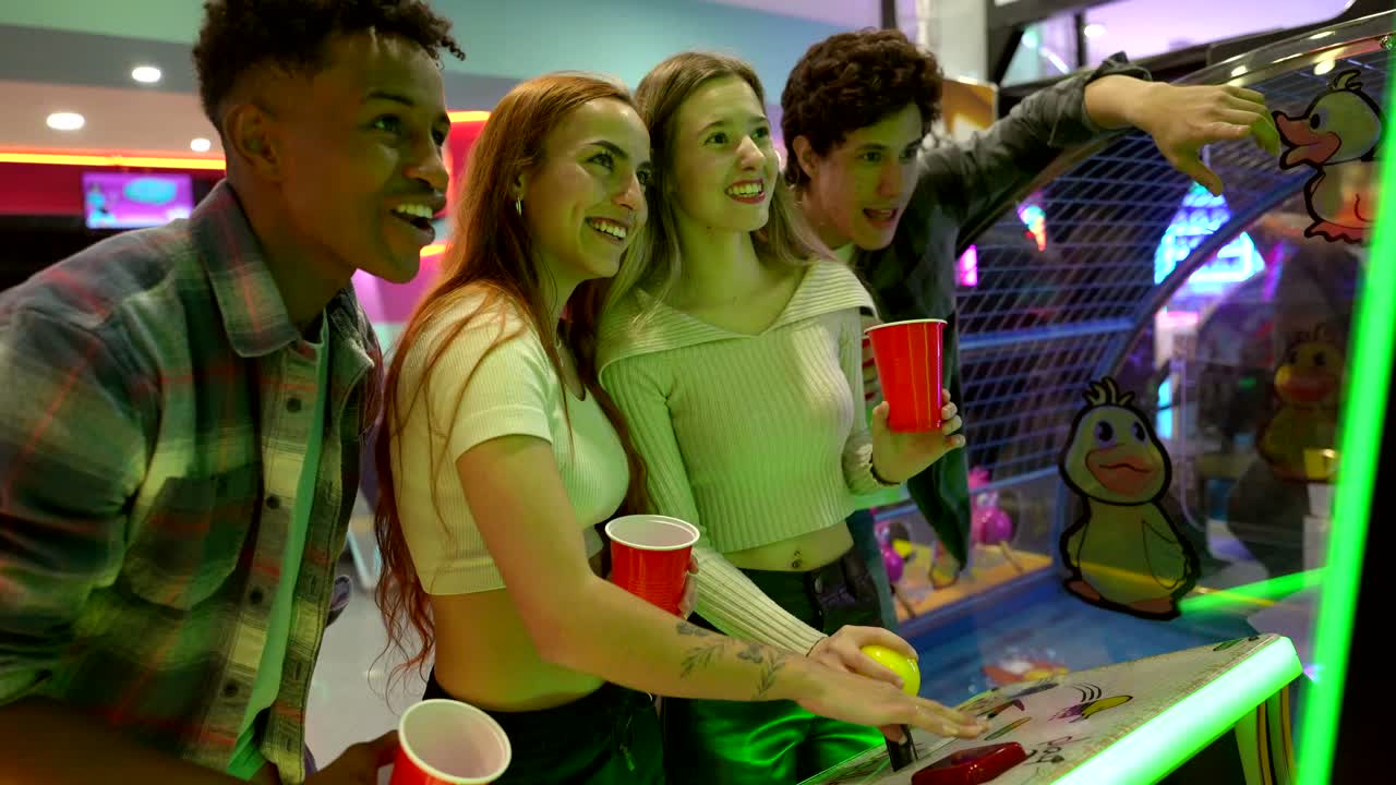 Group of Friends Playing Arcade Games