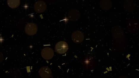 Golden-confetti-and-glowing-stars-moving-against-black-background