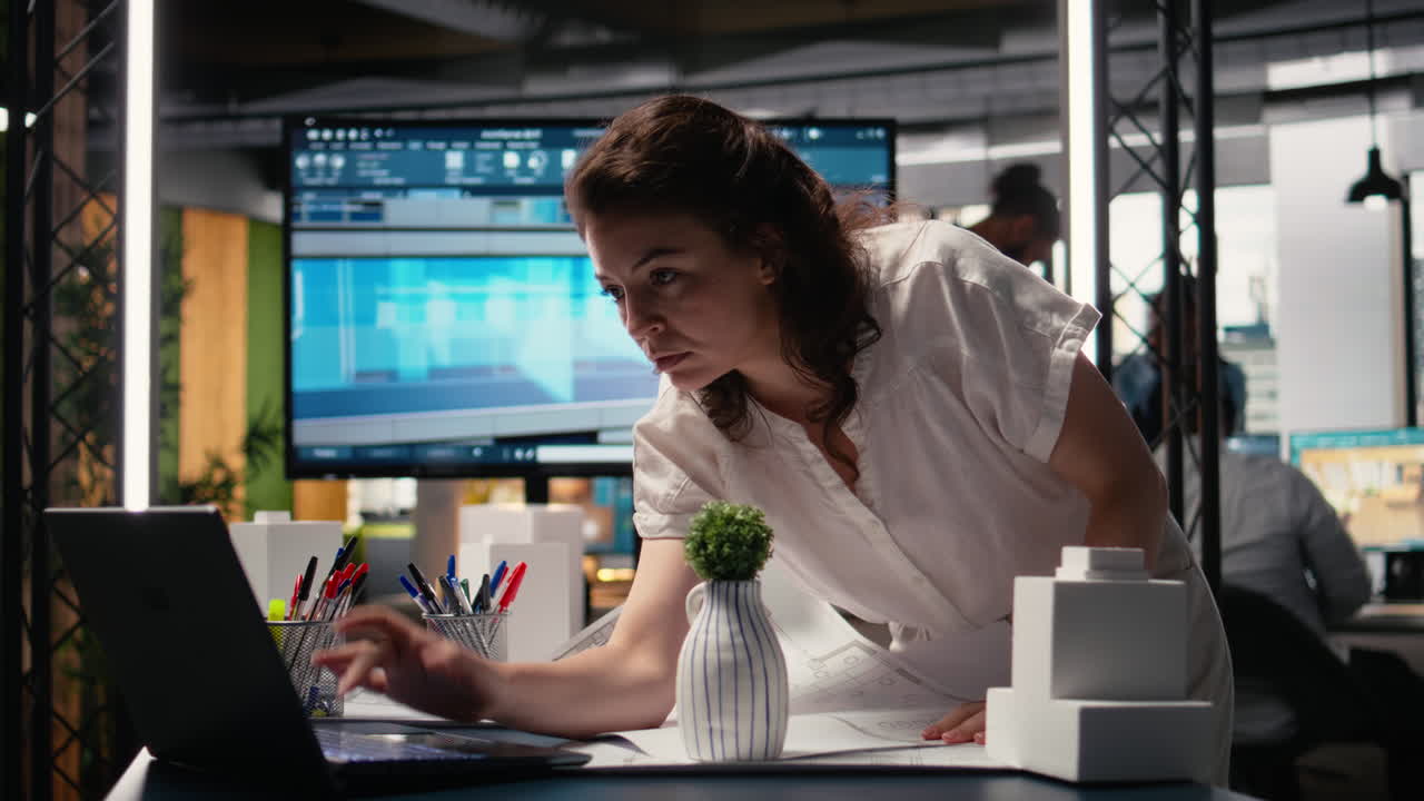 Real estate developer reviews master plan with construction layouts