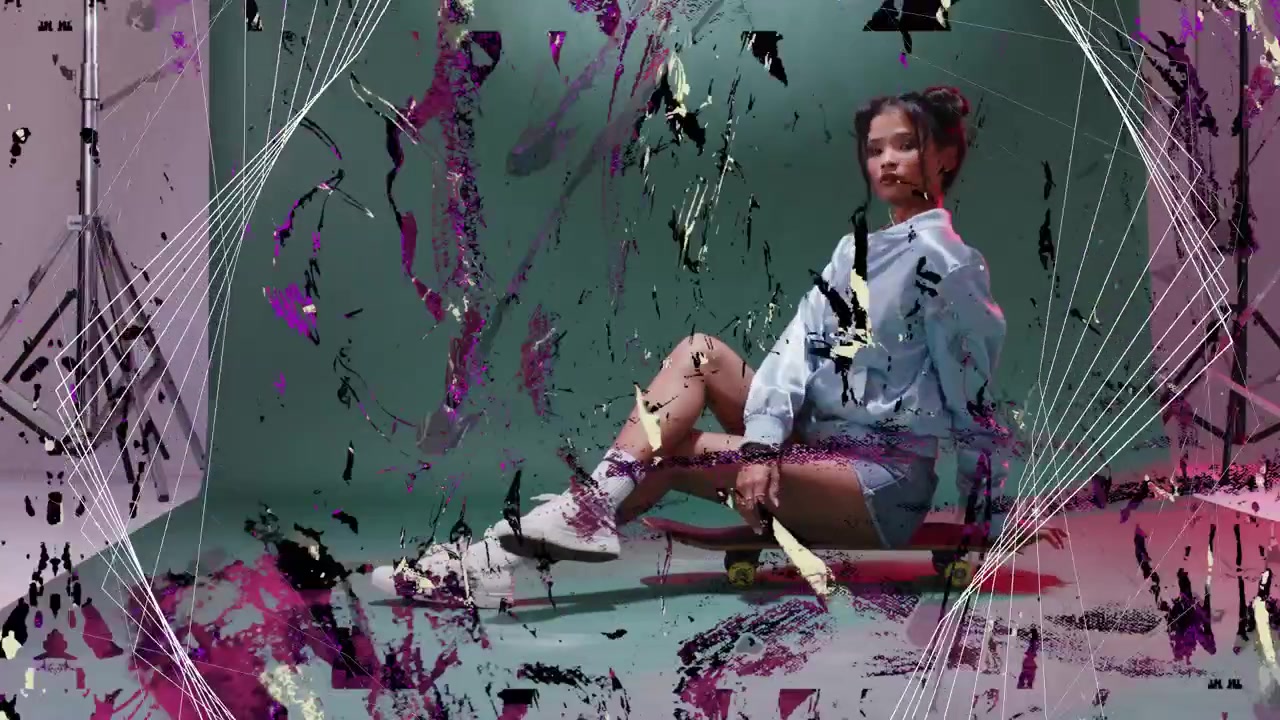 Model sitting on board posing and making splashes and wireframe over green backdrop for style shoot