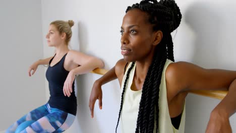 group of women exercising on the barre 4k