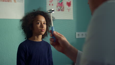 teen girl visit neurologist in modern clinic close up. doctor testing eye reflex
