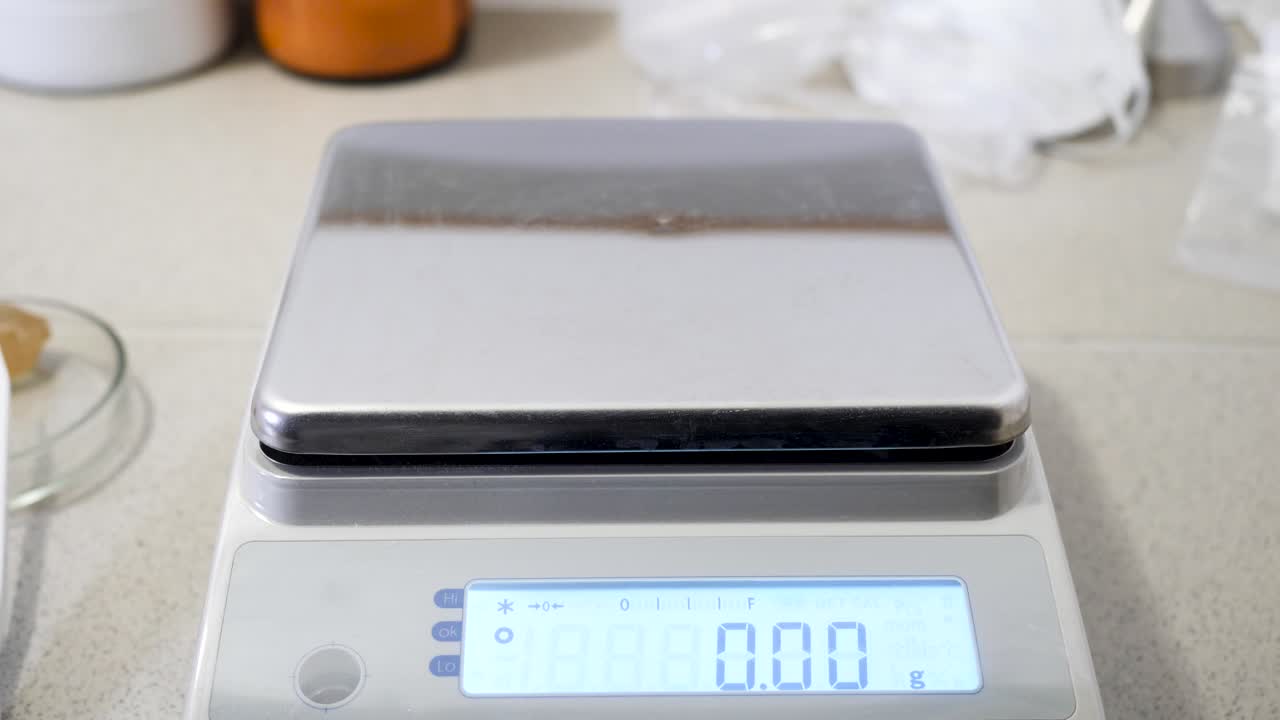 Object being weighed on a digital scale in a laboratory setting