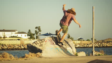 youngster skateboarded makes trick on concrete block and rides away, handheld view