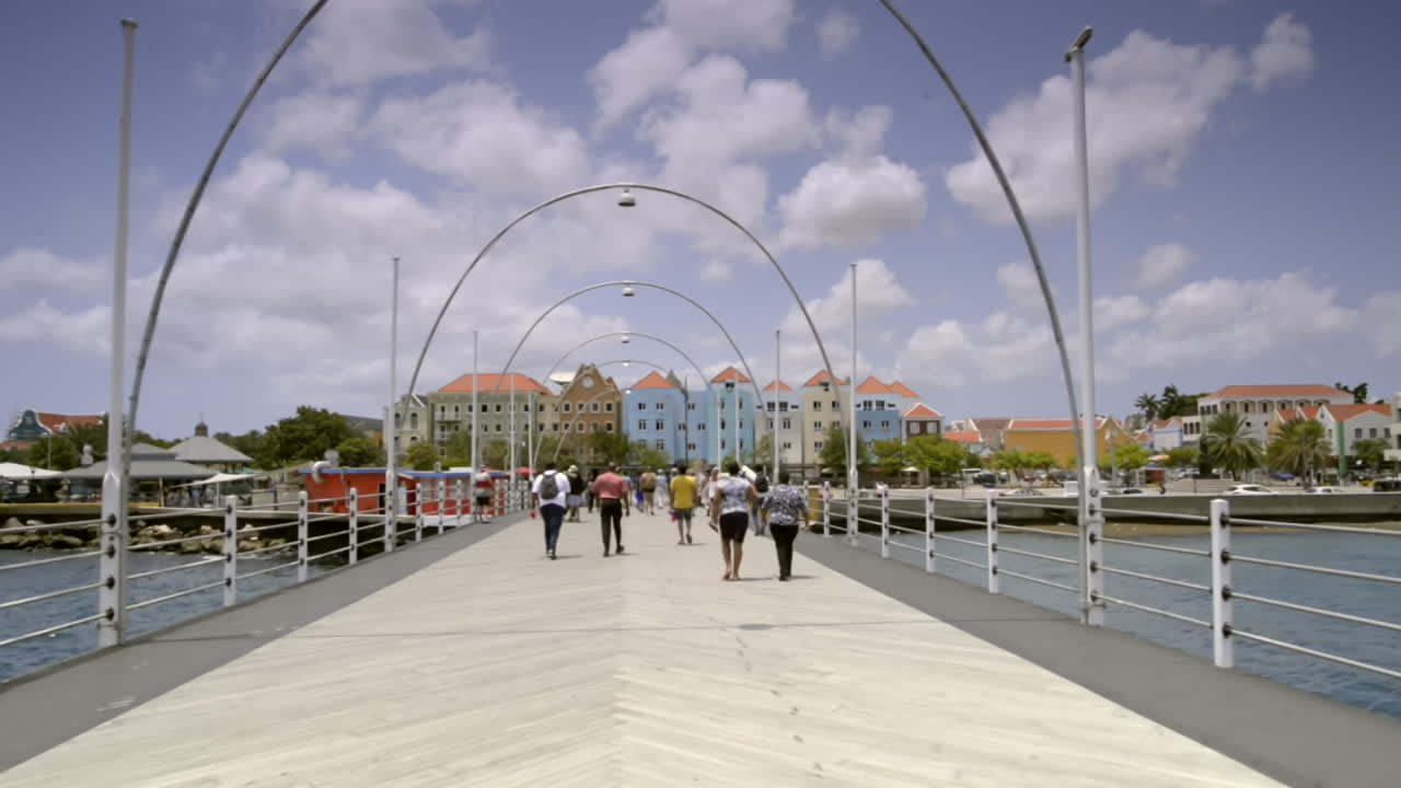 POV walking over Queen Emma Bridge Time lapse. Sint Anna Bay, Willemstad, Curaçao. Travel tourism