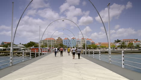 pov walking over queen emma bridge time lapse. sint anna bay, willemstad, curaçao. travel tourism