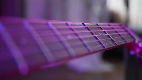 acoustic guitar strings and fretboard on blurred background