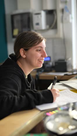 mujer tomando notas en un escritorio
