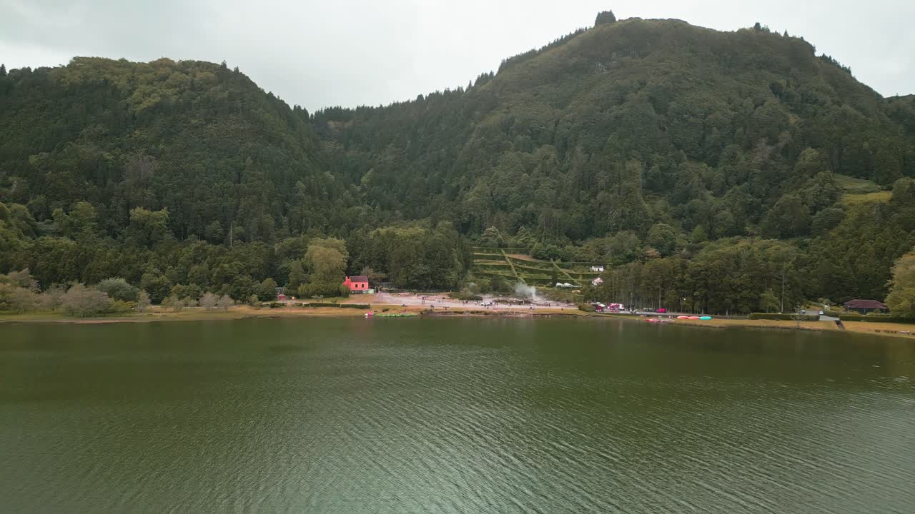 Aerial View of a Serene Lake Surrounded by Lush Green Mountains