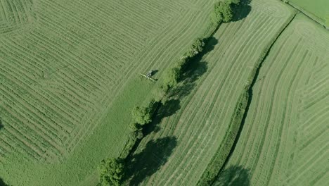 Tracking-aerial-of-a-tractor-processing-cut-grass-reading-for-making-hay