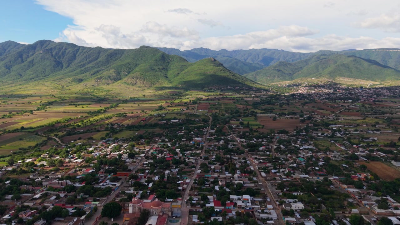 Scenic drone flight over green valleys and mountain ranges in Oaxaca, Mexico