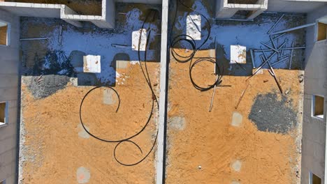 construction of aerial top view on pouring the foundation for a new building with suburbs