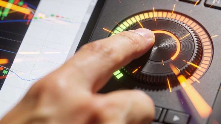 Pressing fingertip, operator hand rotating knob on console, adjusting level with LED ring and chart