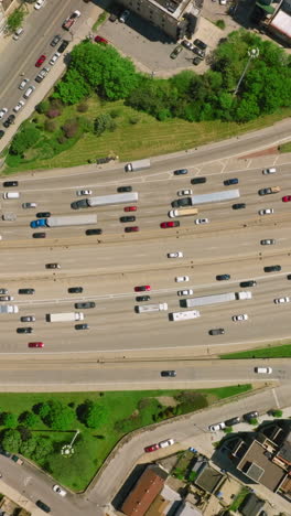 busy traffic on the roads of chicago city. multiple-lane motorways and roads on the bridges with numerous moving cars on them. top view. vertical video