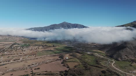 aerial view of clouds over the town of tafí del valle in the province of tucumán, argentina