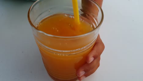 kids playing and mixing orange juice