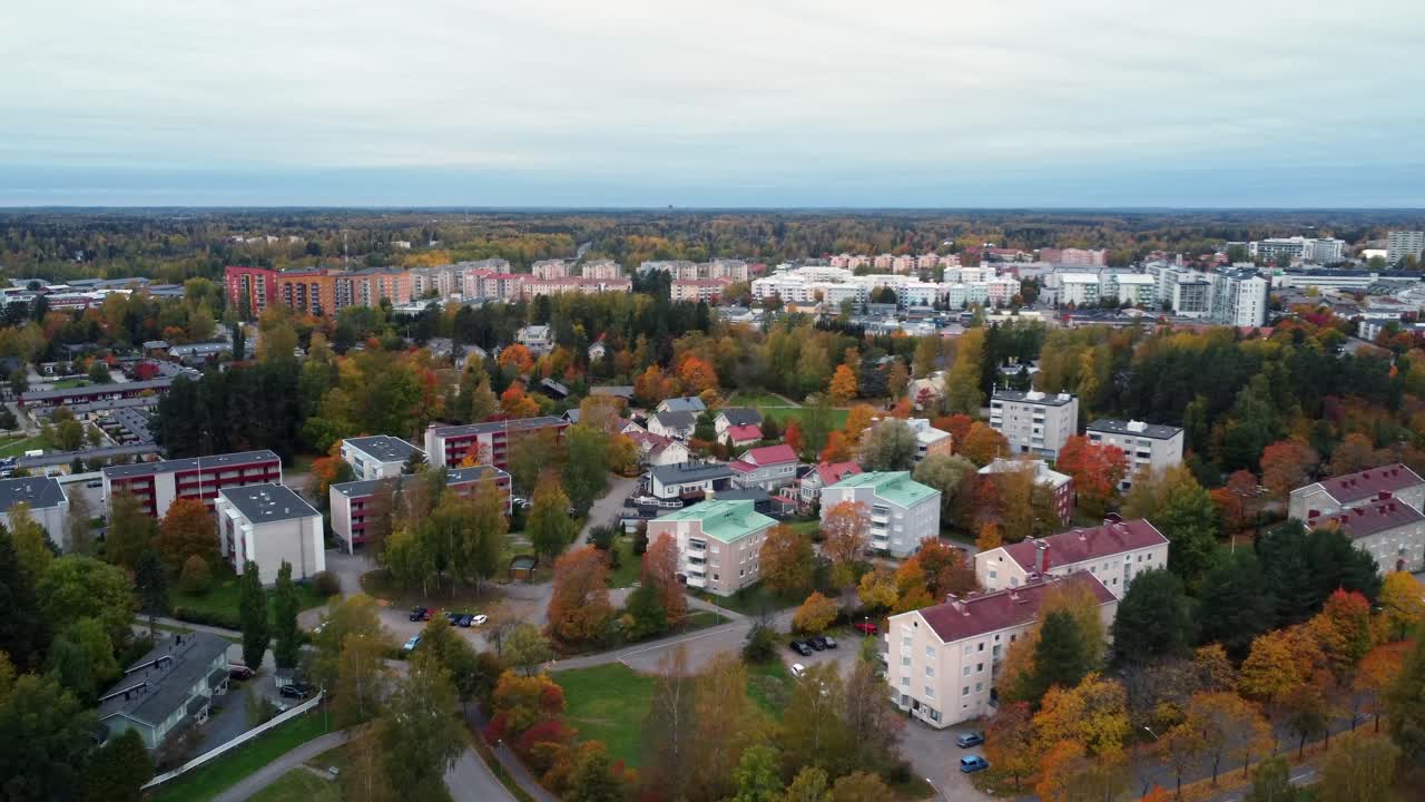 Golden autumn trees brighten northern city in autumn, aerial view