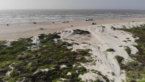 flying over sand dunes with ocean,beach, and sky visible