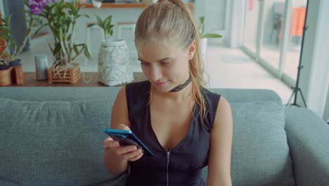 woman using a phone on a couch