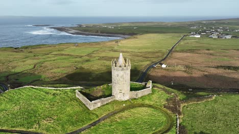 drone doolin castle with the road to doolin village and ferry to the aran islands in winter