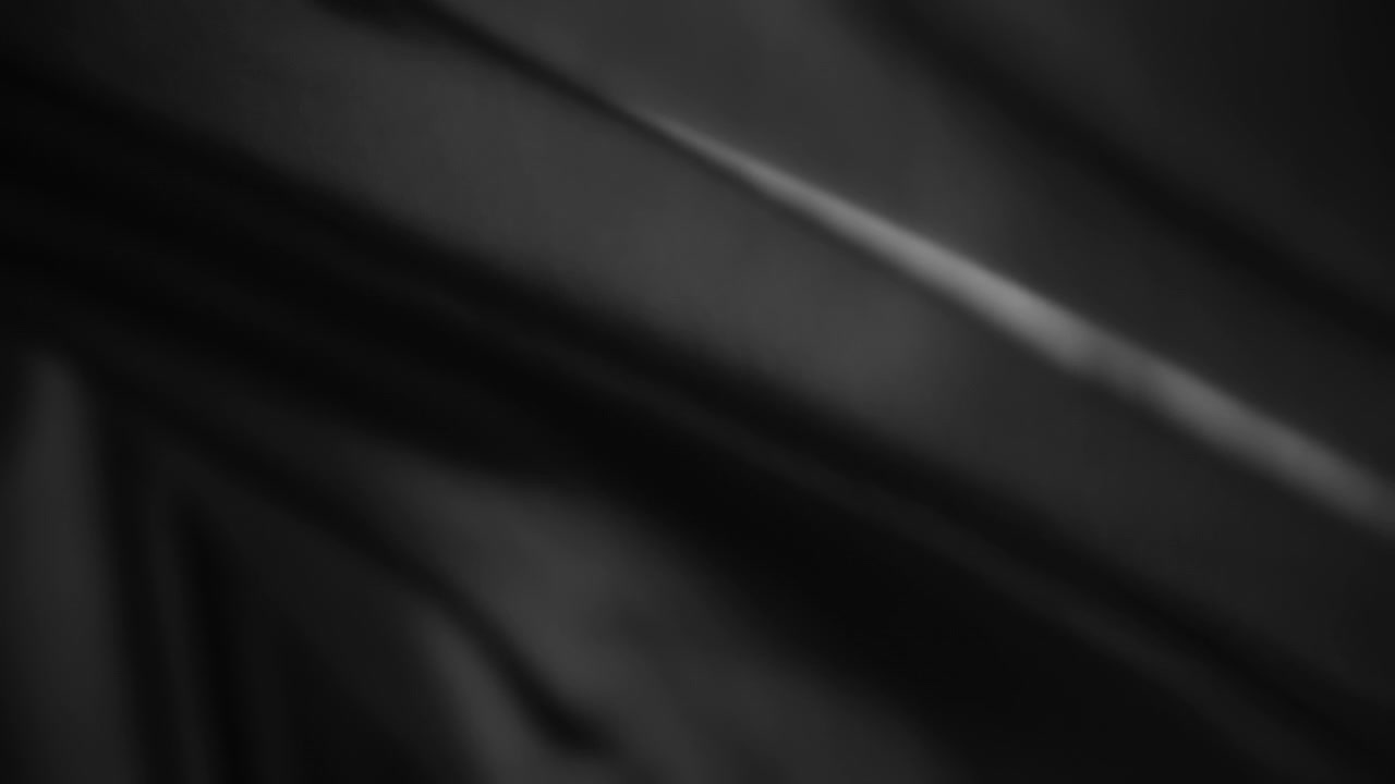 Black chiffon wavy fabric flowing in the wind. Slow motion