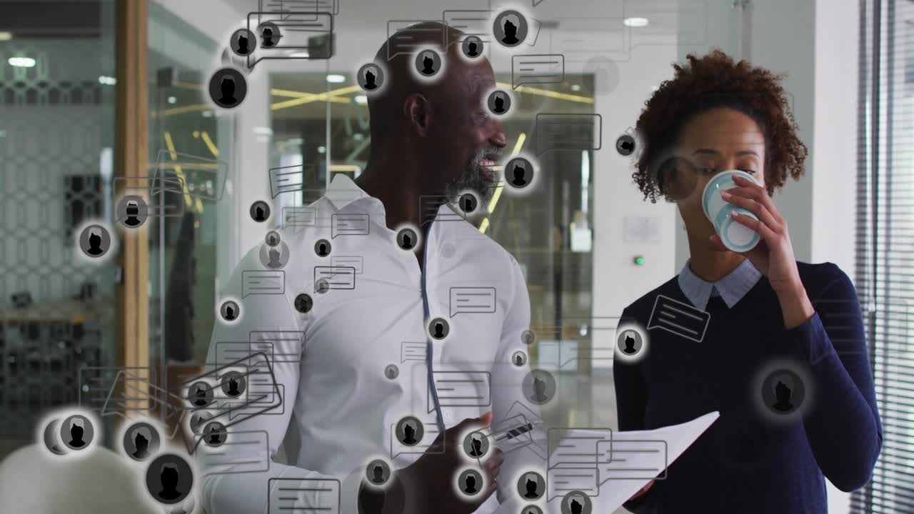 Man tapping doc explaining to woman for briefing animated icons overlaying while woman sipping cup