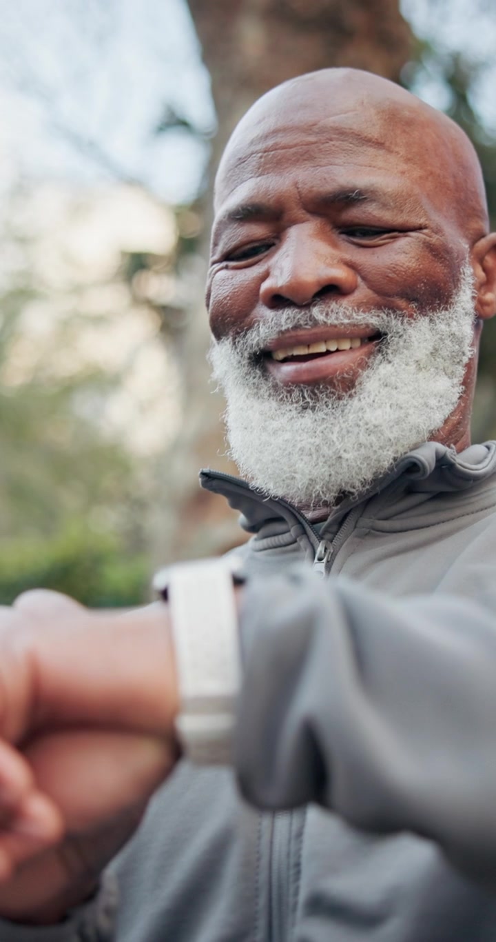 Senior Man Checking Smartwatch During Outdoor Exercise