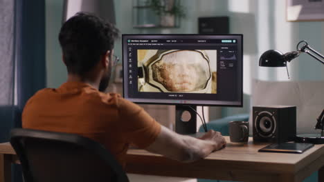man editing an image of an astronaut on a computer