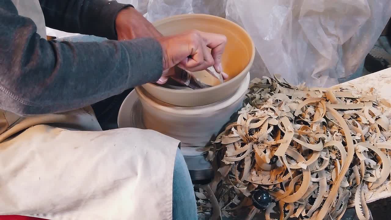 Close Slow Motion Shot of a Craftsman Creating a Bowl on a Pottery Wheel in the Studio