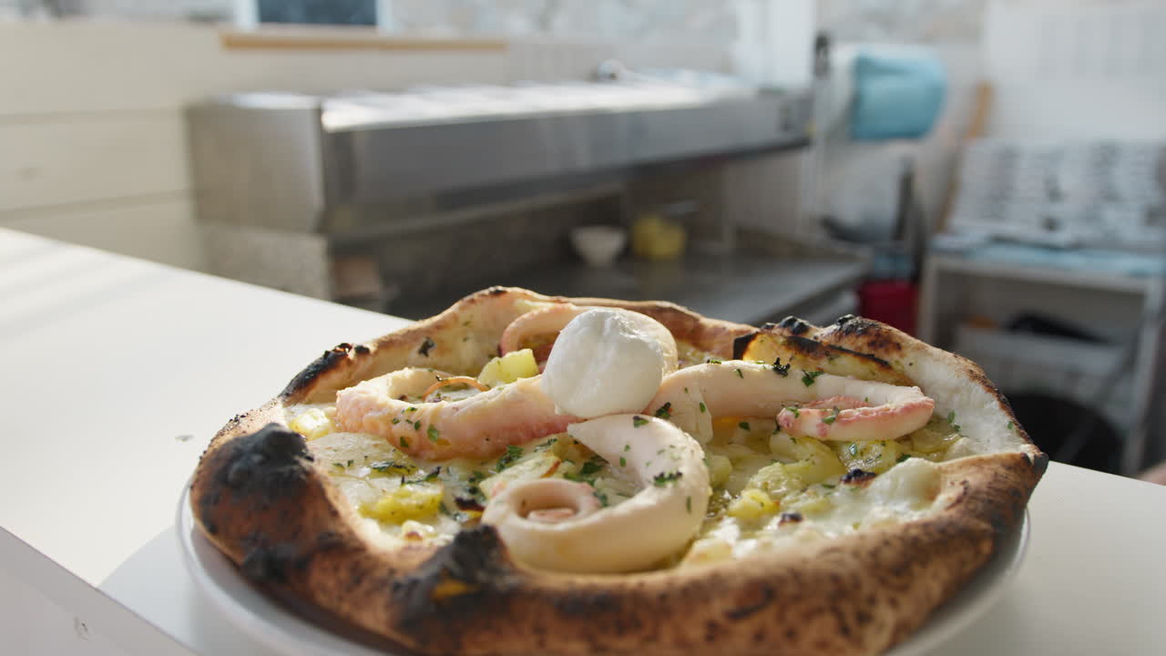 Chef Putting Mozzarella On Top Of The Gourmet Octopus Pizza