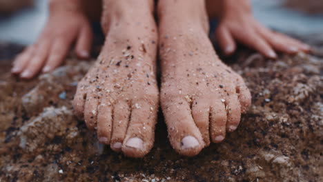 close up of sandy feet young woman sitting on beach barefoot enjoying summer vacation