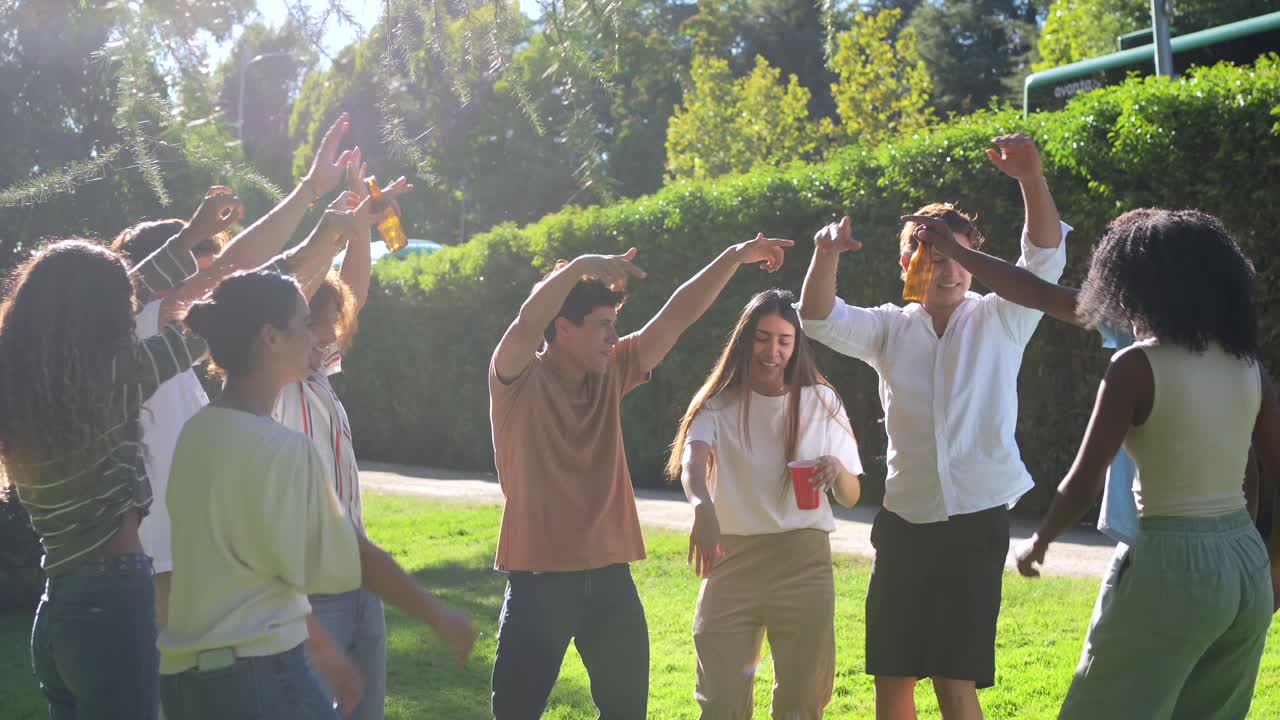 Group of Friends Dancing and Celebrating at an Outdoor Picnic