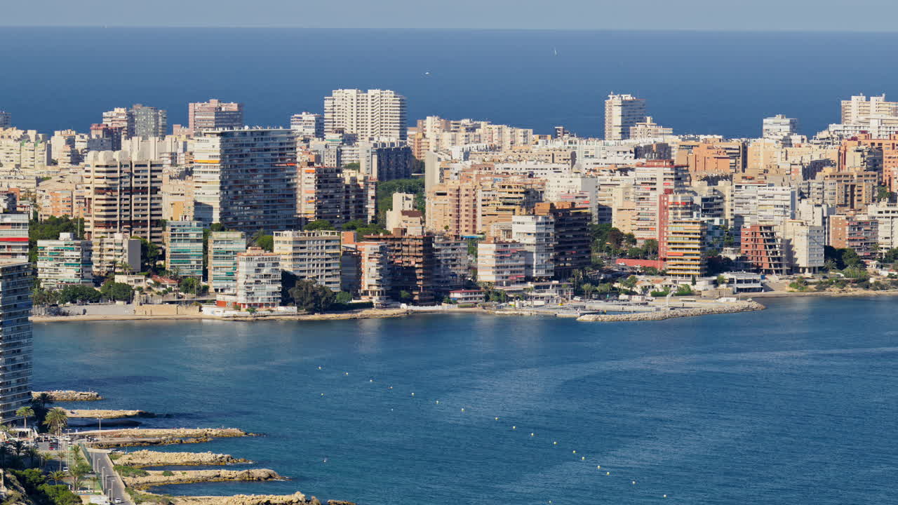 Northward view across coves and residential towers of Albufereta with the sea beyond