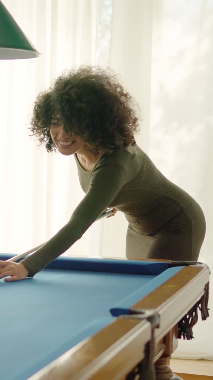 Friends laughing when woman playing awful at pool