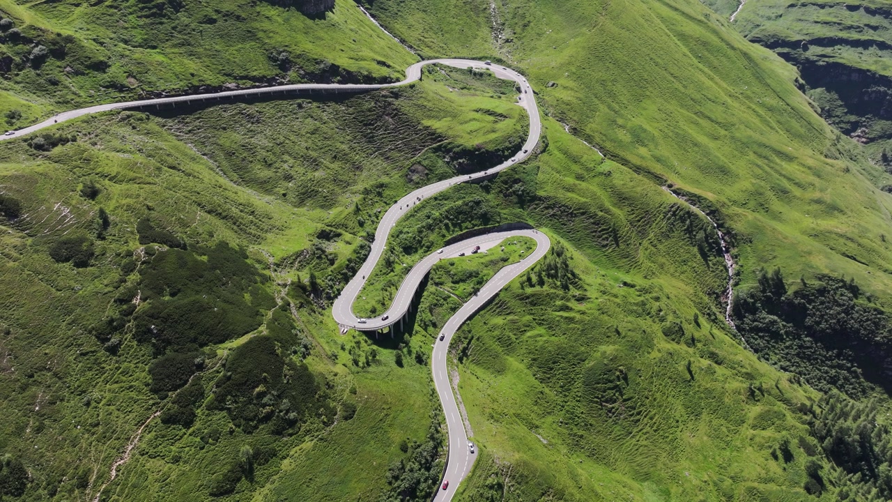 Drone of iconic Grossglockner High Alpine Road winding through green slopes