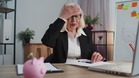 senior business woman analysing paperwork documents loses, bad fortune, loss, deadline, problem