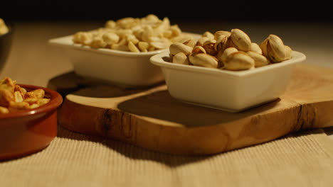 close up of bowls of cashews dry roasted peanuts and pistachio nuts in studio 1