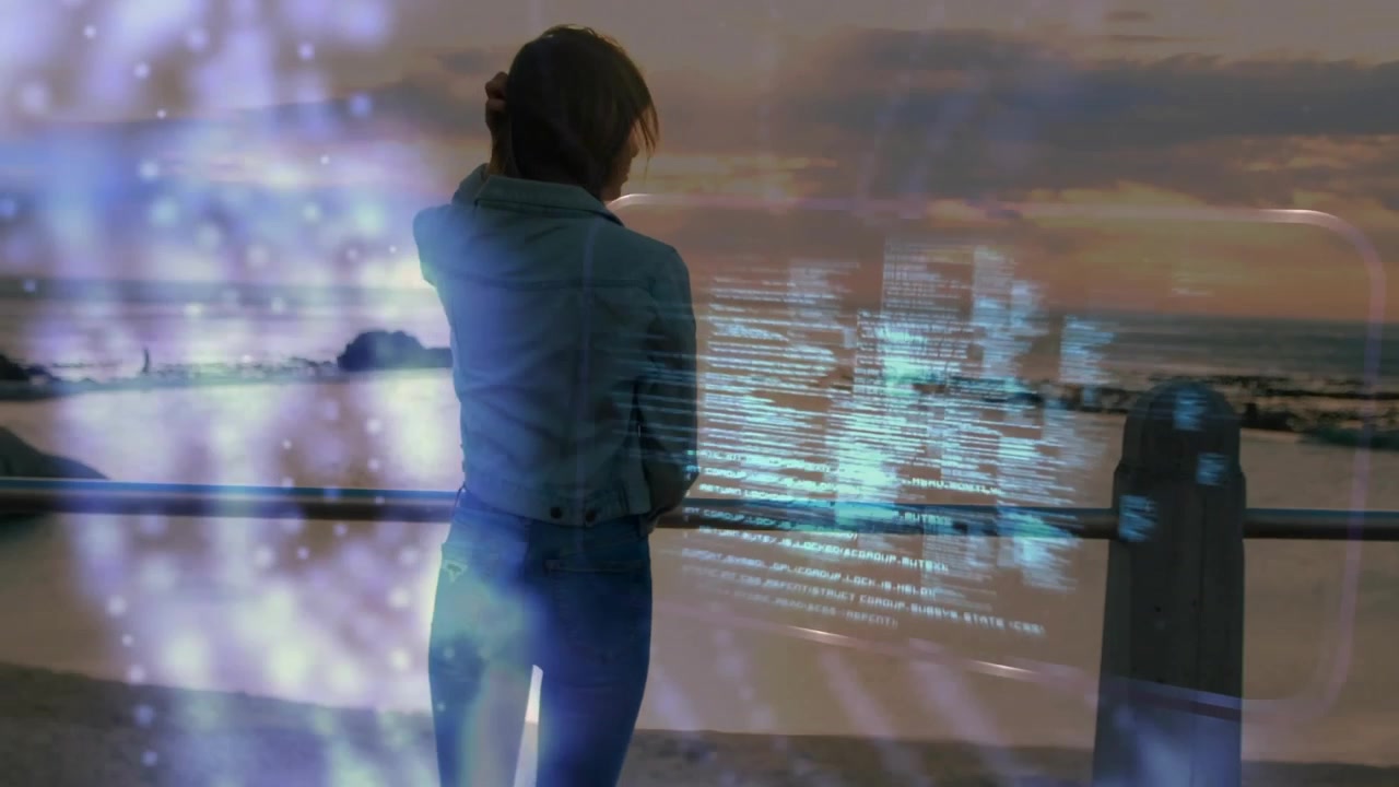 Woman Looking at Digital Data Hologram by the Ocean at Sunset