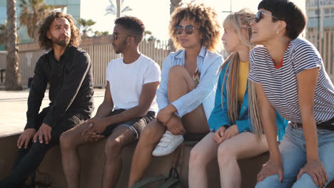 Content-young-friends-chilling-on-city-seafront