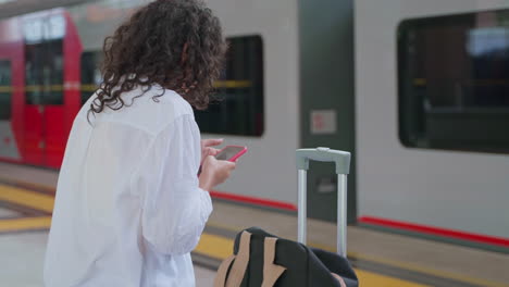 woman waiting for a train at the station