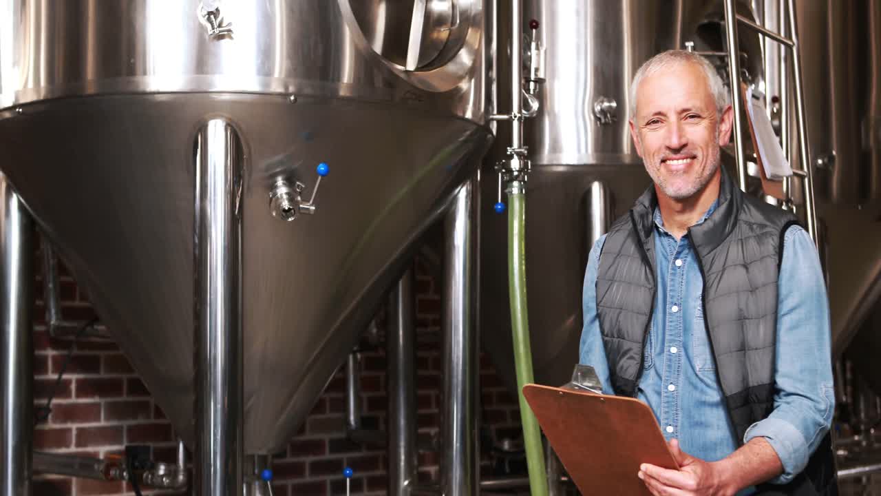 Brewery worker writing on his clipboard