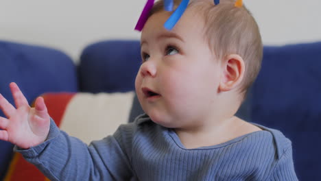 baby-playing-with-rainbow-silk-ribbons-in-slow-motion