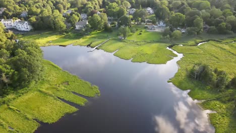 reflection of clouds on tranquil waters of salt marsh near the town