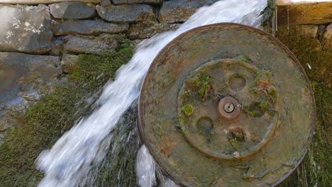 falling water rotates a water wheel